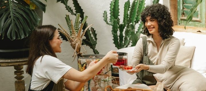 Image of a woman pouring tea for another woman